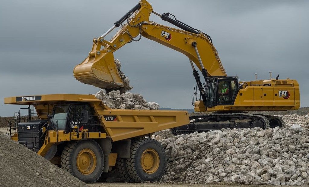 Excavator loading mining truck in open pit mine